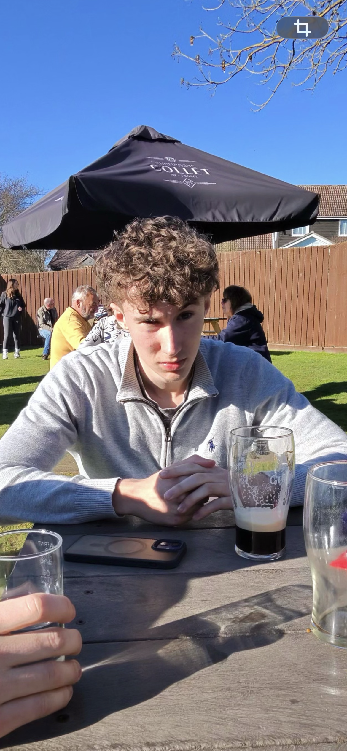 Pal sitting at a picnic table in the sun