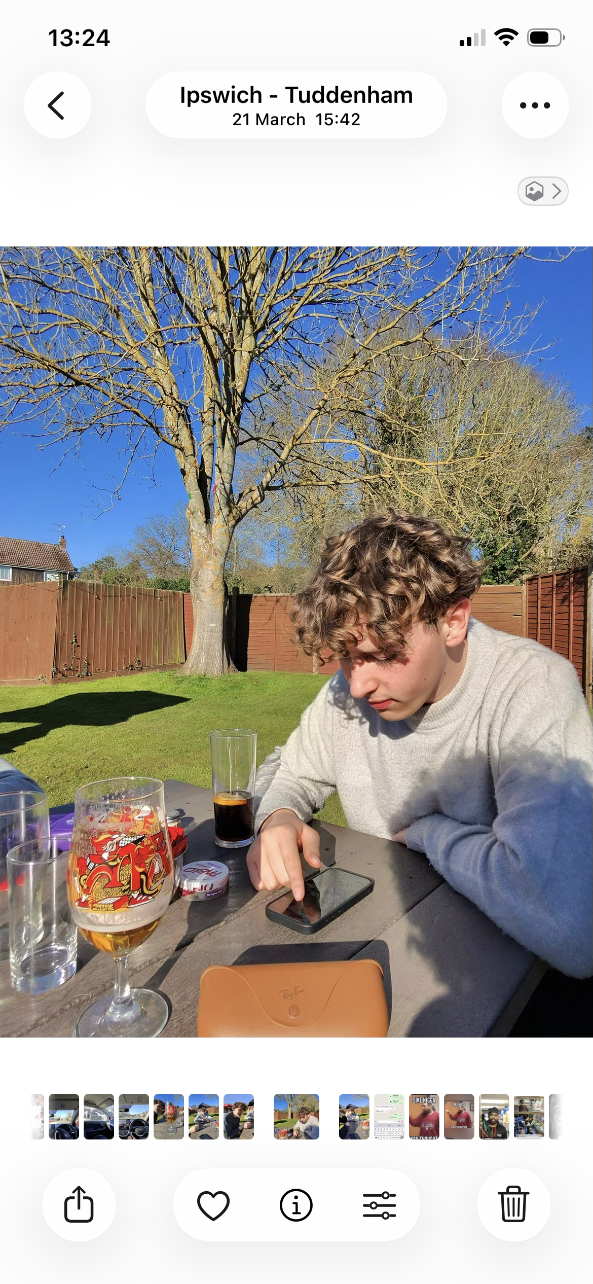 Pal sitting at a table outdoors under a parasol